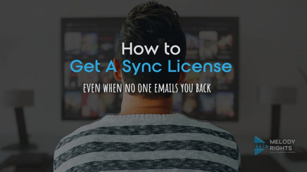 Musician looking at a screen while learning about sync licensing